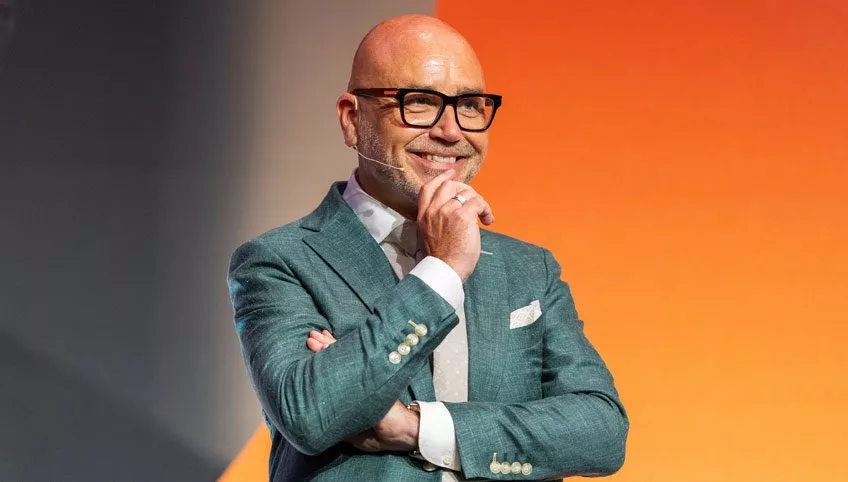 Mannelijke coach in pak staat op het podium