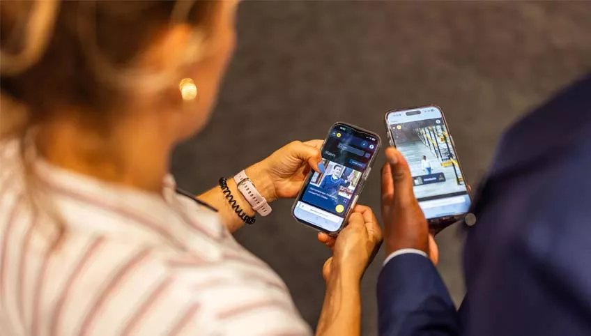Twee mensen kijken op hun telefoon naar het Inner Stance platform