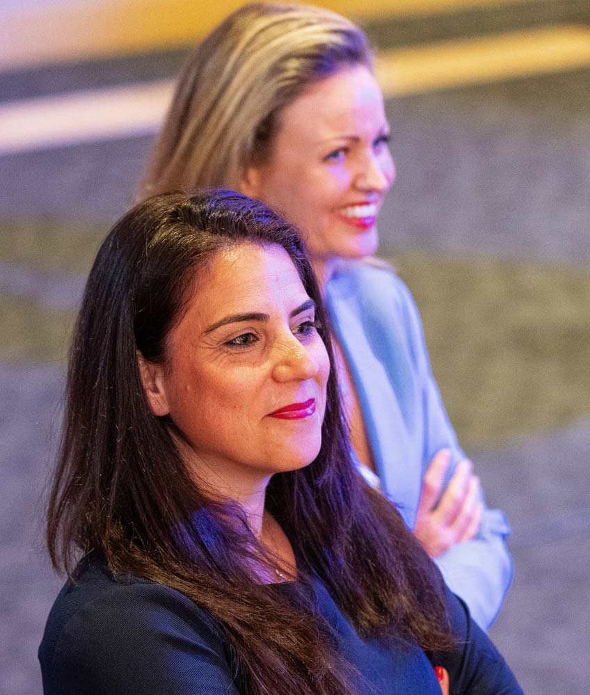 Twee vrouwelijke Inner Stance coaches kijken naar het publiek